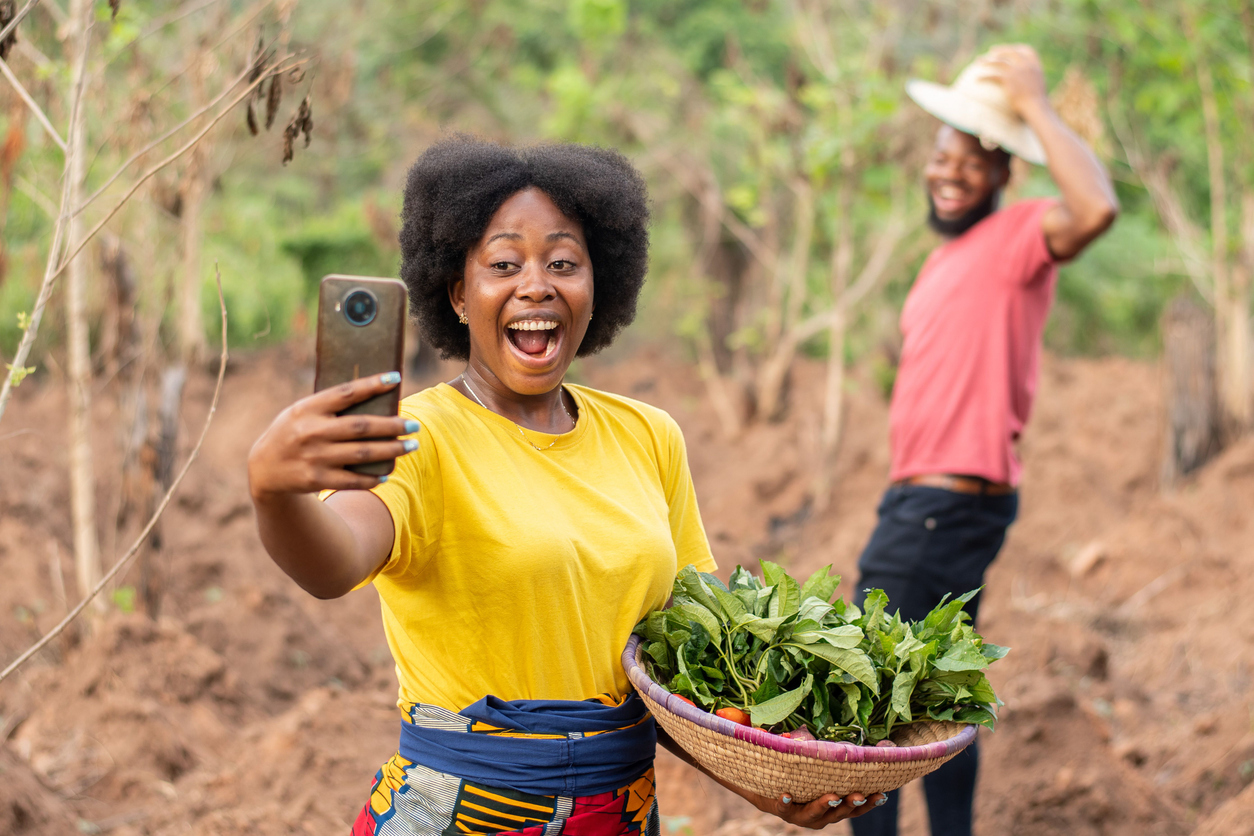 african farmers checking a phone see exciting news